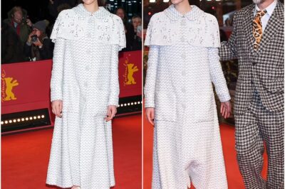 Margaret Qualley exudes elegance in a oversized caped coat as she joins co-star Ethan Hawke for Blue Moon premiere in Berlin